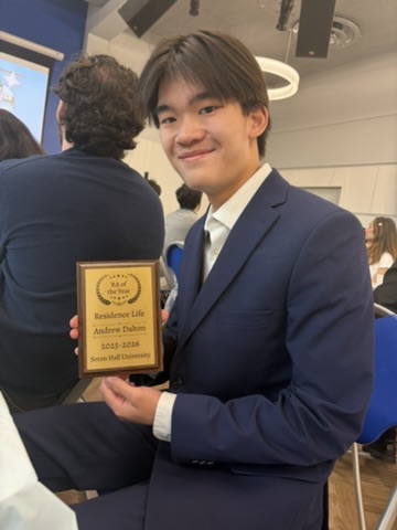 Andrew Dalton holding his Resident Assistant of the Year plaque